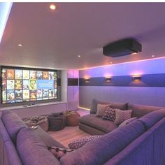 a purple couch sitting in front of a flat screen tv