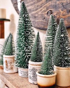 small christmas trees sitting on top of a wooden shelf