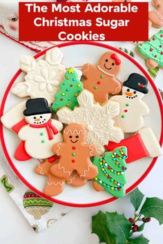 the most adorable christmas sugar cookies on a plate with holly leaves and other holiday decorations