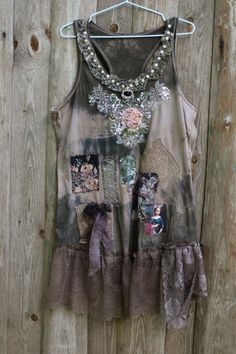 Artsy cotton top is inspired of calm and reserved nature's palette and antique faded textiles. It has been hand dyed uneven shades of beige, brown, gray. The top is embellished with 1930 cotton lace patches, vintage 80' bronze lace, printed silk, printed antique painting detail (of girl with flower), vintage illustration (of cat in the garden), vintage 60' floral printed lace. The neckline has floral embroidered patten and sequin beading, large silk sculpted rose, lace trimming with 80' bronze l Vintage Faded And Bleached Tops, Vintage Cotton Distressed Tops, Bohemian Sleeveless Tops With Lace Patchwork, Chic Lace Patchwork Tank Top, Vintage Lace Patchwork Top