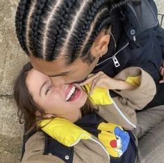 a woman and child are smiling while sitting on the ground