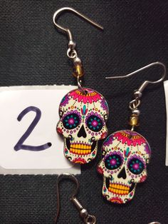 HANDMADE SUGAR SUGAR EARRINGS set 5 --choose from #1-6 and that exact one you will receive :) If you would like many please message us :) DETAIL IS AMAZING! NOT ONE IS THE SAME! COOLER IN PERSON! Set 5 Bohemian Skull Earrings For Gifts, Multicolor Halloween Earrings For Gift, Multicolor Halloween Earrings Gift, Handmade Halloween Earrings Gift, Handmade Earrings For Day Of The Dead, Handmade Skull Earrings For Halloween, Multicolor Skull Jewelry For Day Of The Dead, Bohemian Handmade Skull Earrings, Day Of The Dead Multicolor Skull Jewelry