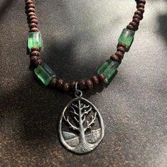 Tree of Life Pendant on a wood and glass bead necklace 15.5. Back in 2008, I moved to Austin and decided to reinvent myself. I bought A LOT of hemp & beaded necklaces/bracelets from an Etsy seller SticksandStonesHemp. I went crazy for her stuff and just bought everything that struck me. Most of these were never worn once (I might have had a wee bit of post-divorce shopping addiction back then) so instead of them sitting sadly in a M Kors shoe box - Im uploading all of them. If you like this list Handmade Wooden Jewelry For Meditation, Nature-inspired Green Jewelry With Wooden Beads, Handmade Wooden Spiritual Necklaces, Spiritual Wooden Beaded Jewelry, Nature-inspired Wooden Beads Jewelry For Meditation, Nature-inspired Wooden Beaded Necklace As Gift, Silver Beaded Necklaces With Wooden Beads For Gifts, Silver Beaded Necklace With Wooden Beads For Gift, Silver Necklaces With Wooden Beads For Gift