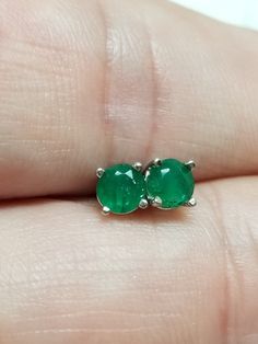 Thanks for shopping our vintage estate store. We tend to sell well below wholesale and truly hope you enjoy all of our items. Many of the items are one of a kind, so please enjoy scrolling through the pictures and hopefully something will catch your eye. Brown spots are from reflections or camera. Nice estate 14k white gold natural .50ct emerald studs. They are nice in color. Custom made in our shop. Little darker than some emeralds, but I love these.  Retails $549 on sale $199 Size: 4.4mm Weight: .74 grams Carat: .25ct per stud Clarity: I1/2 Marked 14k and backs are included. Classic Emerald Earrings For Anniversary, Vintage Emerald Earrings For Anniversary, Aaa Quality Round Emerald Jewelry, Hallmarked Round Emerald Earrings, Emerald Round Earrings For Anniversary, Round Emerald Earrings For Anniversary, 14k Stamped Round Cut Earrings For Gift, Classic Round May Birthstone Earrings, Classic Round Earrings For May Birthstone