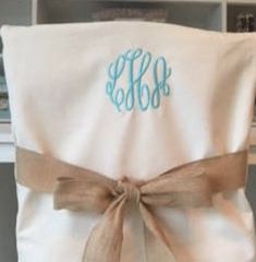 the monogrammed blanket is tied with a brown ribbon