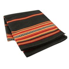 a black and orange striped blanket folded on top of each other