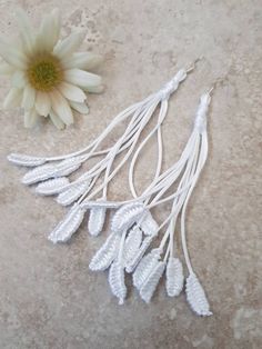 Simple but gorgeous! These stunning white Boho style earrings are so lightweight and comfortable you won't know you are wearing them. An eye catching and unusual design just perfect for a beautiful boho bride.  Earrings as unique as you are. Hand knotted with silky soft 1mm rattail cord on stamped 925 sterling silver wires. Approx 12cm total length Also available in other colours. See other listings. https://www.silkandrainbows.etsy.com  *I try to represent the colours as accurately as possible Handmade White Dangle Plug Earrings, Bohemian White Bridal Earrings For Pierced Ears, White Sterling Silver Bridal Earrings For Pierced Ears, White Bohemian Bridal Dangle Earrings, Elegant White Plug Earrings With Ear Wire, Elegant Macrame Dangle Earrings, Elegant Dangle Macrame Earrings, White Macrame Dangle Jewelry, White Handmade Adjustable Earrings