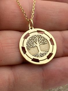 "Dainty 14k Solid Gold Tree of life Necklace, Gold Tree Necklace, Custom Tree of life necklace, Personalized  Gold Tree Of Life Necklace 14k Solid Gold Choose What Size You Want the Pendant Using The First Option Box Choose Chain Length Or Without Chain Using The Second Option Box Photos Are For The 20mm / 0.78 inch Diameter Pendant Pendant thickness : 0.7mm  Contact us if you want it thicker Inner diameter of jump ring : 5mm Contact us if you need it bigger  Chain width : 1.30mm     ♥  Material of pendant and chain: Solid Gold k14  ♥  Packaging: All of our jewelry are beautifully boxed and ready for gifting For more personalized designs take a look here: ♥ www.etsy.com/listing/736955132 ♥ www.etsy.com/listing/819494857 ♥ www.etsy.com/listing/823397880 ♥ www.etsy.com/listing/769847320 ♥ ww Golden Tree Necklace, Symbolic Gold Jewelry With Tree Of Life, Tree Of Life Pendant Necklaces For Anniversary, Tree Of Life Jewelry Gift, 14k Yellow Gold Tree Of Life Jewelry, Yellow Gold Tree Of Life Pendant Jewelry, Tree Of Life Round Jewelry For Anniversary, Tree Of Life Round Pendant Jewelry For Anniversary, Etched Necklaces For Anniversary