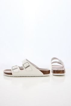 Introducing Maibulun's Signature Double Strap Footbed Sandal in White. Designed for ultimate comfort and style, these sandals feature a double strap design for secure support and a hard footbed for extra ankle support. Perfect for a day out or a casual stroll, elevate your look with these signature sandals. 0.59" inch heel Slip-on / buckle closure Hard Cushioned footbed Man-made leather upper Man-made lining EVA sole White Synthetic Sandals With Adjustable Strap, White Adjustable Strap Synthetic Sandals, White Flat Sandals With Adjustable Strap, White Footbed Sandals With Arch Support For Beach, White Slip-on Footbed Sandals With Arch Support, White Double Strap Footbed Sandals For Beach, Adjustable Double Strap Synthetic Footbed Sandals, Comfortable White Sandals With Adjustable Strap, White Open Toe Footbed Sandals With Adjustable Strap