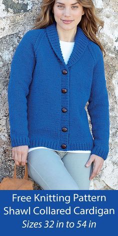 a woman is wearing a blue cardigan and holding a brown bag in front of a stone wall