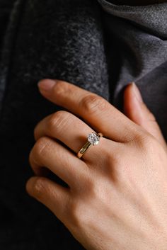 a woman's hand with a diamond ring on it