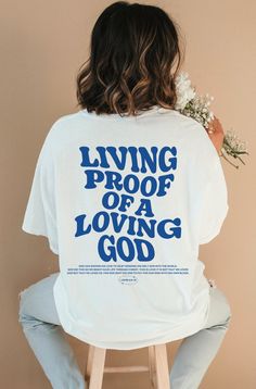 Introducing our new "Living Proof of a Loving God " t-shirt, a perfect expression of faith and style. This Christian shirt features a timeless design and a powerful message. This shirt is not only a fashionable choice but also a meaningful one. It serves as a reminder of the saving grace of Jesus Christ and the hope and redemption that comes with it. It's a great way to boldly express your faith and share your beliefs with others! ⁑ F U N ⁑ F A C T S ⁑ ☼ Unisex Adult Sizes ☼ 100% Cotton ☼ Washer Bible Verse T Shirt, Jesus Clothes, Christian Shirts Designs, Aesthetic Christian, Christian Streetwear, Loving God, Christian Men, Jesus Tshirts, Jesus Is Life