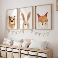 three framed pictures hang on the wall above a bench in a room with white walls