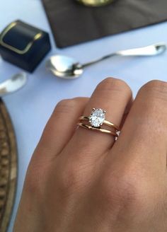 a close up of a person's hand with a ring on it