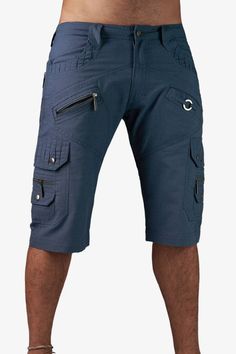 High quality crafted shorts with many thoughtful details in blue. It has a total of 13 pockets - one is well hidden ;-) Two slide-in pockets with decorative seams in front and two pockets in the back with zippers offer enough space for storage. On each trouser leg is a side pocket with snaps. On this side pocket two small pockets were put on. In front there is another pocket under the pockets, on the left leg with a useful key ring.  Inside the waistband is a drawstring. Thus, you can adjust the pants perfectly to your size. The fabric is made of tightly woven cotton twill and the seams are sewn double. This makes the pants durable and comfortable at the same time. Super suitable for all travels and adventures on and off the dancefloor ;-)  - 13 pockets in total - metal ring for keychain - Blue Cargo Pocket Shorts, Blue Cargo Pants With Hip Pockets For Summer, Denim Blue Cargo Shorts, Blue Summer Cargo Pants With Hip Pockets, Utility Denim Blue Shorts With Cargo Pockets, Utility Denim Blue Cargo Shorts, Blue Shorts With Multiple Pockets For Summer, Blue Bottoms With Multiple Pockets For Summer, Blue Summer Shorts With Multiple Pockets