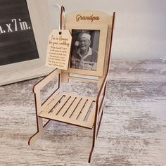 a wooden chair with a plaque attached to the back that says grandpa in front of it