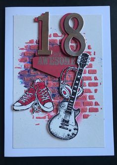 a card with an image of a guitar and shoes on it, in front of a brick wall