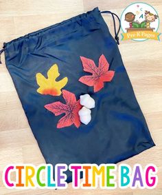 a blue bag with fall leaves painted on it and the words circle time bag written below