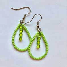 These handmade, beaded teardrop earrings come in a variety of colors. This pair is a light green color. Perfect for all occasions and super comfortable to wear. These earrings are not heavy at all and can be worn comfortably all day. The earrings are 2 cm across. Every pair is unique and  may look somewhat different than the picture. I love making these earrings and hope you enjoy wearing them! Green Beaded Teardrop Jewelry, Trendy Teardrop Dangling Bead Jewelry, Green Beaded Dangle Teardrop Earrings, Trendy Teardrop Jewelry With Dangling Beads, Trendy Beaded Teardrop Jewelry, Trendy Teardrop Beaded Earrings, Trendy Teardrop Beaded Jewelry, Trendy Teardrop Beaded Earrings With Ear Wire, Bohemian Green Teardrop Earrings With Ear Wire