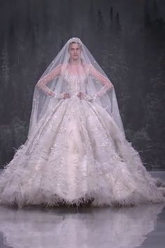 a woman in a white wedding dress and veil