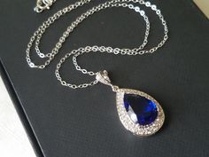 Wedding Sapphire Royal Blue Navy Blue Cubic Zirconia Teardrop Halo Pendant with .925 Sterling Silver Chain Bridal Necklace. Glamorous and elegant, this necklace is perfect for weddings or special occasions such as birthdays, anniversaries, graduations, proms...or whatever you can imagine! CHAIN is 18 inches (45.7 cm) long. PENDANT is about 1.18 inch (3cm) long including bail. Handmade necklace, is made with .925 Sterling Silver 18 inches long cable chain, Rhodium Plated pear shaped Sapphire Navy Blue Teardrop Jewelry For Wedding, Blue Drop Jewelry For Wedding, Blue Teardrop Wedding Jewelry, Sapphire Drop Necklace For Wedding, Blue Teardrop Pendant Jewelry For Formal Occasions, Blue Teardrop Necklace For Wedding, Blue Teardrop Pendant For Formal Occasions, Blue Pear-shaped Necklace For Formal Occasions, Blue Bridal Jewelry