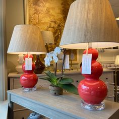 two red lamps sitting on top of a table