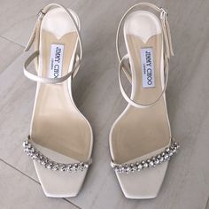 Jimmy Choo Meira Embellished Sandal Color Latte Square Open Toe Buckled Ankle-Strap Closure Heel Height 85mm (3.25”) 100% Leather Upper / Lining / Sole Made In Italy Size 41.5 Insole 10.5 In / 26.67 Cm Runs Small; Order 1/2 Size Up Original Packaging Including Box, Protective Plastic, Shoe Bag, Inserts Worn Twice Embellished Sandals, White Heels, Jimmy Choo Shoes, Cream White, Women's Shoes Sandals, Jimmy Choo, Ankle Strap, Open Toe, Shoes Sandals