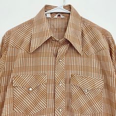 "Vintage 70's brown and white plaid long sleeve western shirt. Pearlescent snaps with pointy collar and accent pockets on front. Originally owned by a country line dancer. Permanent press. Size 16 32, but please check measurements to ensure fit. Measurements- Shoulders- 17.5\" Chest- 20.75\" Sleeve length- 23\" Overall length- 31\" COWBOY // WESTERN // RETRO // PLAID // CHECK" Western Brown Collared Tops, Western Style Brown Collared Top, Long Sleeve Brown Shirt For Ranch, Western Brown Tops With Snap Buttons, Fitted Brown Shirt For Rodeo, Collared Shirt For Ranch In Fall, Fitted Western Brown Shirt, Brown Fitted Western Shirt, Fitted Brown Western Shirt