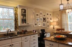 a kitchen with white cabinets and granite counter tops