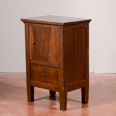 a small wooden cabinet with two drawers on one side and an open drawer on the other