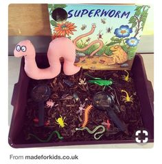 a box filled with toys and books on top of a table