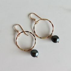 Tahitian Pearl Hoop Earrings~ Elegant earrings with beautiful Tahitian pearls that dangle from 14k gold fill textured hoops. You are sure to get compliments while wearing these stunning beauties! Hoops 26mm. Pearl approx. 10mm. Check out our Tahitian Pearl Jewelry Section~ https://www.etsy.com/shop/HanaMauiCreations?section_id=7842721&ref=shopsection_leftnav_10 Shop~ http://www.etsy.com/shop/HanaMauiCreations?ref=pr_shop_more International buyers please read our shipping policies before ordering Tahitian Pearls Jewelry, Jewelry Elegant, Hawaii Beach, Hoop Earrings Gold, Earrings Elegant, Pearl Hoop Earrings, Tahitian Pearls, Gold Texture, Jewelry Earrings Hoops