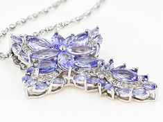 Pre-Owned 6.23ctw marquise and .12ctw round tanzanite with .31ctw round white diamond and .05ctw round blue diamond rhodium over sterling silver cross pendant with 24" singapore chain. Measures approximately 1.75"L x 1.29"W. Lobster clasp. 3mm bail. 2" extender. Finished back. .  This product may be a customer return, vendor sample, or on-air display and is not in its originally manufactured condition.  It may not be new.  In some instances, these items are repackaged by JTV. Diamond White Multi-stone Marquise Jewelry, Diamond White Marquise Multi-stone Jewelry, Silver Tanzanite Jewelry With Diamond Accents, Dazzling Tanzanite Jewelry With Diamond Accents, Purple Diamond Marquise Jewelry, Purple Marquise Diamond Jewelry, Marquise Diamond Jewelry With Gemstone Accents, White Gold Tanzanite Jewelry With Diamond Accents, Silver Marquise Jewelry With Gemstone Accents