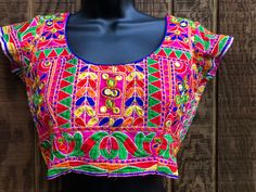 "Colorful embroidered crop top.  Hook eye closure in back. No tags - estimated size small/mediu - please see measurements. In good vintage condition.  Measurements taken across front laid flat. 17\" across front armpit to armpit or 34\" around 13.5\" across front of waist  14\" length top of shoulder to bottom" Traditional Multicolor Choli For Spring, Summer Multicolor Choli With Floral Embroidery, Summer Floral Embroidered Multicolor Choli, Summer Floral Embroidery Multicolor Choli, Summer Multicolor Floral Embroidered Choli, Fitted Floral Embroidery Crop Top For Festival, Fitted Floral Embroidered Crop Top For Festival, Festive Multicolor Embroidered Fitted Top, Festival Multicolor Choli With Floral Embroidery