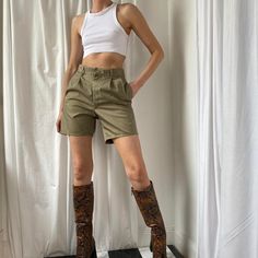 Amazing 90s vintage khaki / Sage / Olive tailored high waisted city shorts. Boy / Bermuda style. Khaki green cotton shorts with with zip fastening, belt hoops, side pockets and pin tucked pleat front detail. Buttoned back pockets. seen on a size 8 (5ft9) would be more relaxed on smaller sizes. Laidback preppy utility city style, perfect with an oversized blazer. These are in great condition. Multiple sizes available. Model is wearing a size UK 12 in pictures. Model size: UK 10 5ft9. Measurements Cheap Khaki Cargo Shorts With Belt Loops, Safari Shorts Outfit, High Waist Khaki Shorts For Spring, High Waist Khaki Shorts For Summer, Trendy Khaki Shorts For Spring, Khaki Shorts For Spring Day Out, Spring Khaki Shorts For Day Out, Vintage Khaki Bottoms For Fall, Khaki Short Length Bottoms For Spring