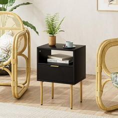 two wicker chairs and a side table in a living room with plants on the floor