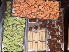 there are many different types of food on the trays in this buffet table together