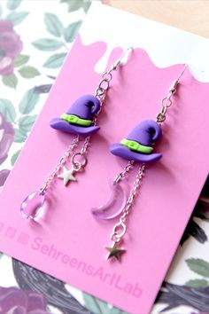 Cute and Witchy earrings, assembled and crafted for Halloween 2023 ♥ #earrings #halloween earrings #halloween jewelry #halloween decor #halloween decorations #Halloween idea #witchy aesthetic #creepy cute #spooky earrings #spooky jewelry #kawaii #kawaii cute #kawaii earrings #kawaii core #witch #witchy cute #witch aesthetic #spooky #magic #jewelry #earrings handmade # witch hat #witch's hat #hat earrings #nocturnal #night #magical earrings #wizard #magic spell #hex #earrings for her #gift idea Cute Halloween Party Jewelry, Purple Earrings For Halloween Party, Witchy Halloween Party Earrings, Whimsical Halloween Dangle Jewelry, Novelty Purple Jewelry For Party, Cute Halloween Earrings For Pierced Ears, Witchy Halloween Earrings, Handmade Witchy Earrings For Halloween, Novelty Purple Party Jewelry