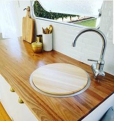 a kitchen counter with a wooden cutting board on it