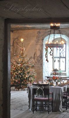 a dining room filled with furniture and a christmas tree