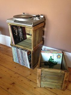 an old record player sitting on top of a wooden stand