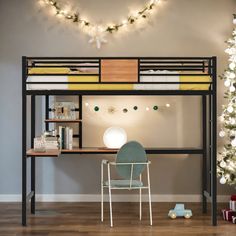 a bunk bed with a desk underneath it and christmas decorations on the wall behind it