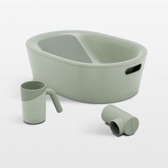 a green bathtub with two cups next to it