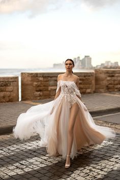 a woman is walking down the street in a dress