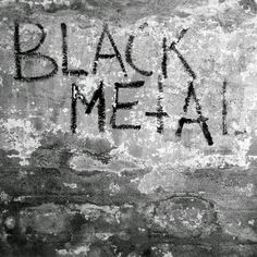 black and white photograph of graffiti writing on the side of an old brick wall that reads'black metal '