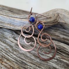 Boho Copper Earrings with Howlite Stone -handcrafted  -made of solid copper metal -unique one of a kind spiral design with wire wrap detail -featuring pretty cobalt blue howlite stone -lightweight and comfortable to wear -copper plated brass ear hooks - nickel free, lead free and cadmium free Size:  2.25 inches long (measurement is from top of ear hook to bottom of earring) A little over .75 inch wide Bookmark my page and return often as I add new styles frequently.... tfuniquetwists.etsy.com Handmade Spiral Wrap Earrings, Unique Handmade Spiral Wrap Earrings, Handmade Unique Spiral Wrap Earrings, Handmade Spiral Copper Wire Earrings, Bohemian Brass Wrap Earrings Wire Wrapped, Bohemian Spiral Wrap Earrings With Ear Wire, Wire Wrapped Spiral Copper Earrings, Copper Spiral Wire Wrapped Earrings, Wire Wrapped Copper Spiral Earrings