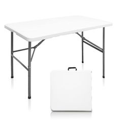 a white table with a suit case underneath it