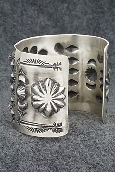 This stunning sterling silver bracelet was made by Navajo silversmith Elvira Bill. The inside is signed Elvira Bill and stamped sterling.Size: 5 7/8" (will fit up to a 7 1/4" wrist)Gap: 1 3/8"Width: 2"Free shipping on all orders! We ship with USPS and always include tracking. All orders ship within a day of payment.Returns are accepted up to 30 days after you receive your order. Just send us a message. Our shop offers cash back or store credit. The item must be returned in new condition. Artisan Sterling Silver Concho Cuff Bracelet, Artisan Silver Concho Cuff Bracelet, Southwestern Silver Bracelets With Concho, Sterling Silver Bracelet, Sterling Silver Bracelets, Silver Bracelet, Gap, Stamp, Bracelet