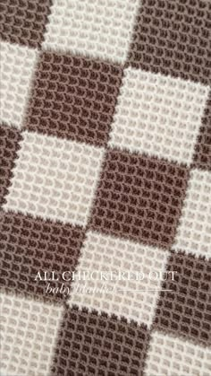 a brown and white checkerboard pattern is shown on the fabric in this photo