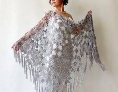 a woman wearing a white crocheted shawl